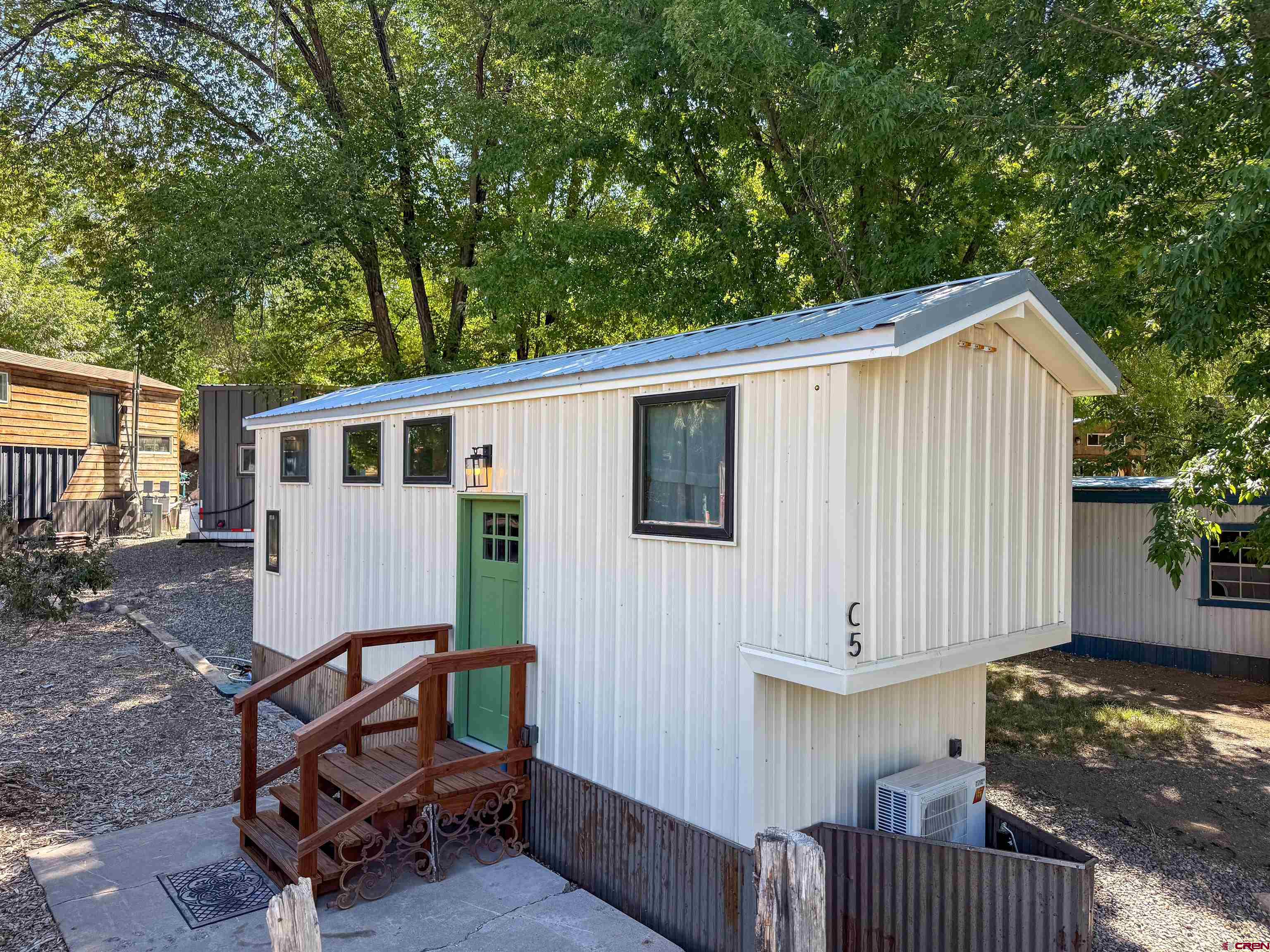 a view of backyard with a deck and furniture