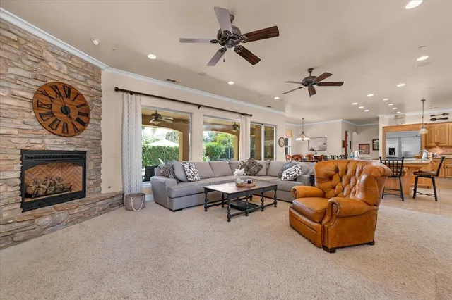 a large kitchen with granite countertop a large stove top oven a sink a counter space and cabinets