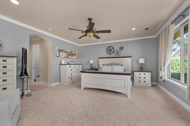 a living room with a dresser and a mirror