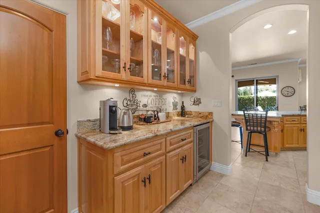 a living room with a fireplace and a floor to ceiling window