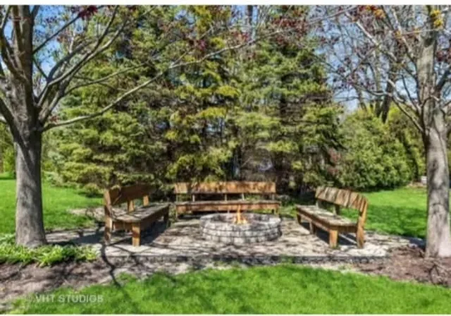 a backyard of a house with table and chairs