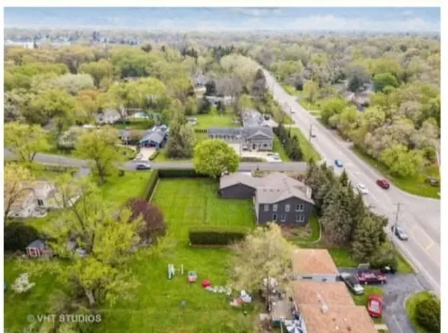 an aerial view of a house with a yard