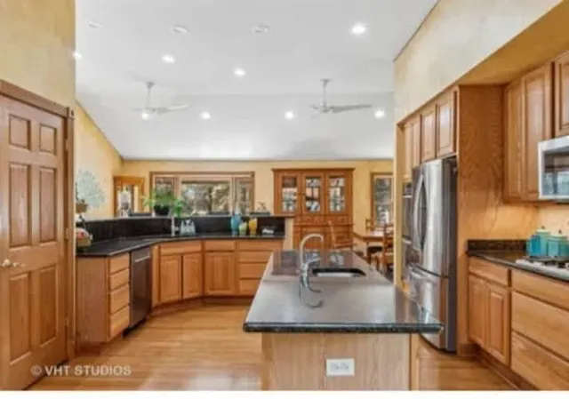 a kitchen with stainless steel appliances granite countertop a sink stove and refrigerator