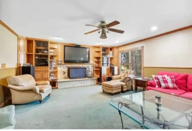 a living room with furniture stairs and a flat screen tv