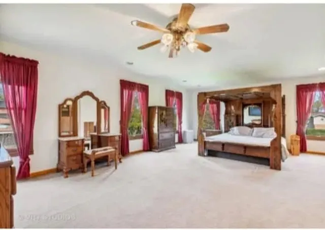 a living room with furniture and a ceiling fan