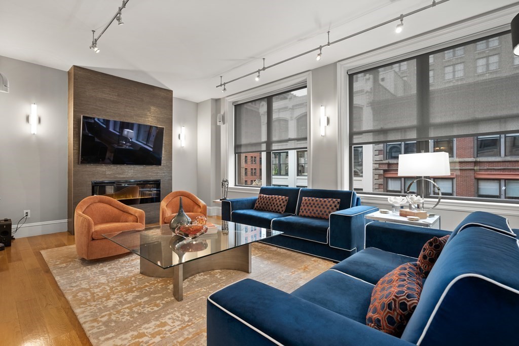 100 State Street, Unit 5 Boston, MA 02109 - Photo 1 of 18 a living room with furniture fireplace and a large window
