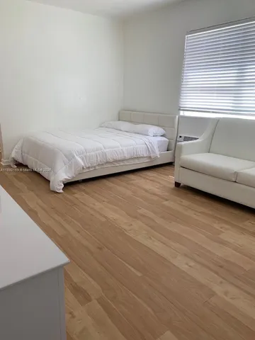 a bedroom with a bed and a couch