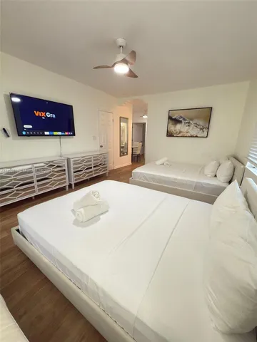 a spacious bedroom with a bed a couch and a window