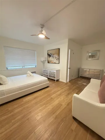 a spacious bedroom with a bed and furniture