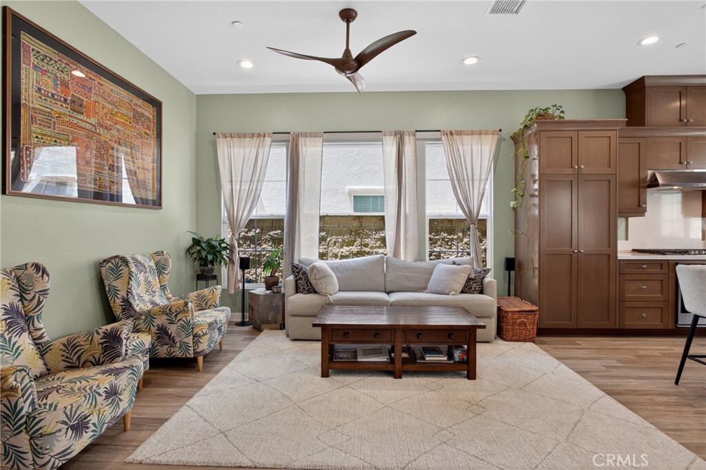 20667 West Beech Porter Ranch, CA 91326 - Photo 5 of 60 Inviting family room filled with natural light, featuring expansive windows, high ceilings, designer ceiling fan, and a seamless connection to the kitchen for comfortable everyday living and entertaining.