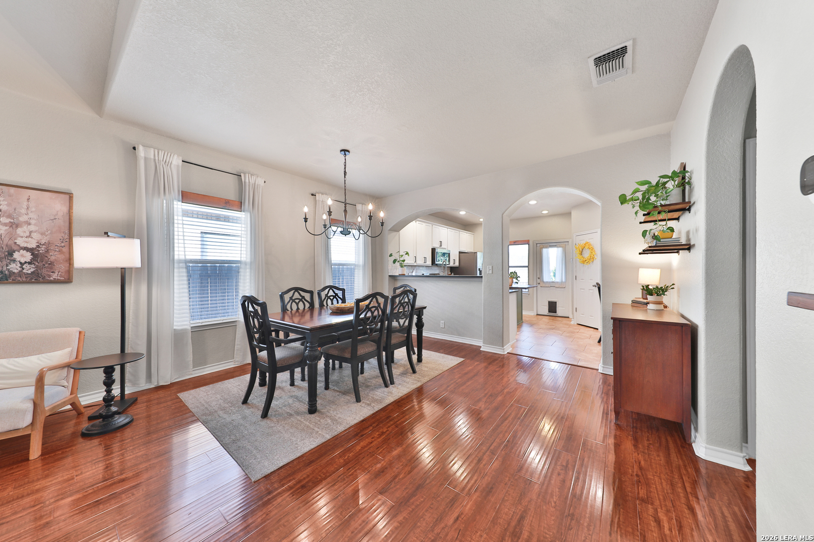 10414 Pecne Path Helotes, TX 78023 - Photo 11 of 42 a view of a dining room with furniture and wooden floor