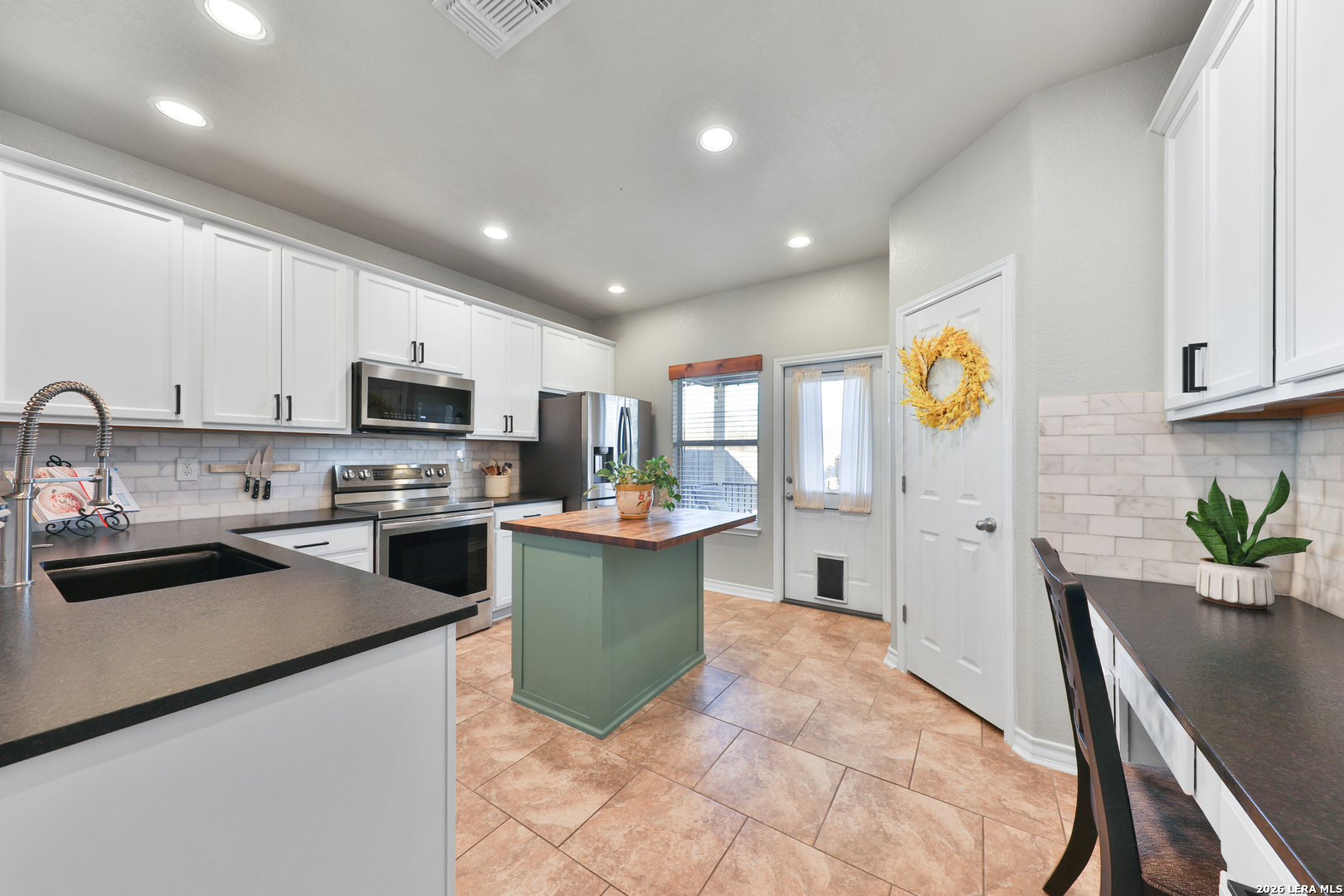 10414 Pecne Path Helotes, TX 78023 - Photo 15 of 42 a kitchen with sink a counter top space stainless steel appliances and cabinets
