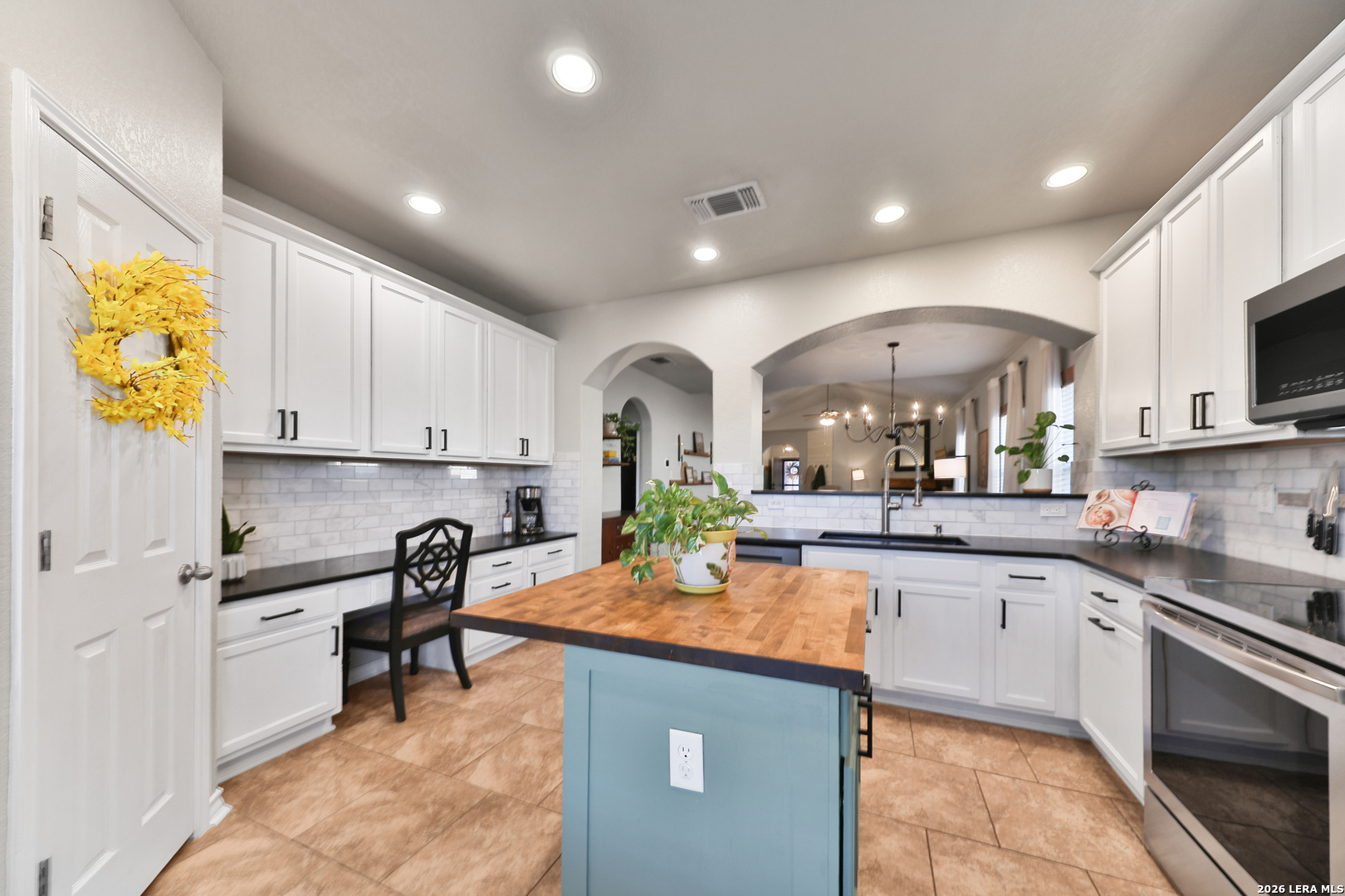 10414 Pecne Path Helotes, TX 78023 - Photo 19 of 42 a kitchen with kitchen island granite countertop lots of counter top space and stainless steel appliances