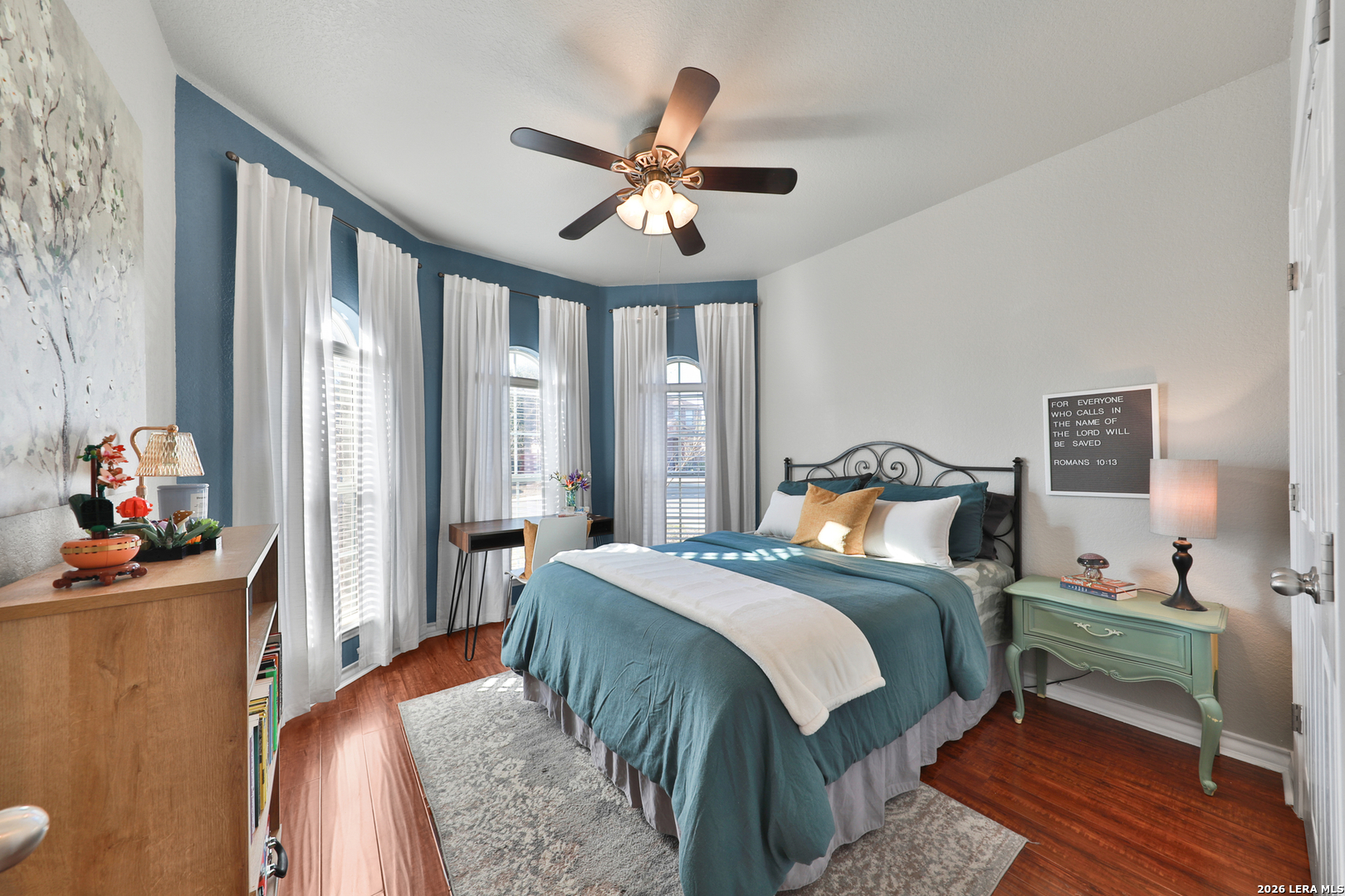 10414 Pecne Path Helotes, TX 78023 - Photo 20 of 42 a bedroom with a bed and a chandelier