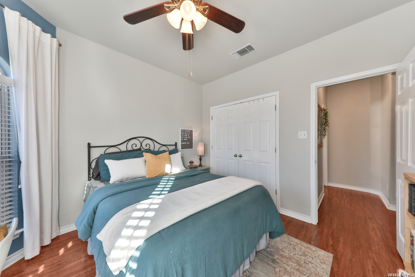 10414 Pecne Path Helotes, TX 78023 - Photo 21 of 42 a bedroom with a bed and wooden floor