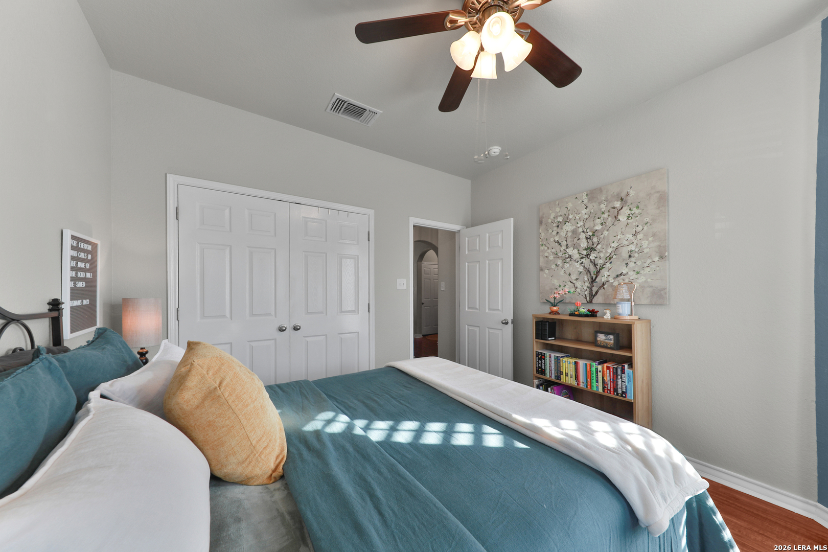 10414 Pecne Path Helotes, TX 78023 - Photo 22 of 42 a bedroom with a bed and a chandelier