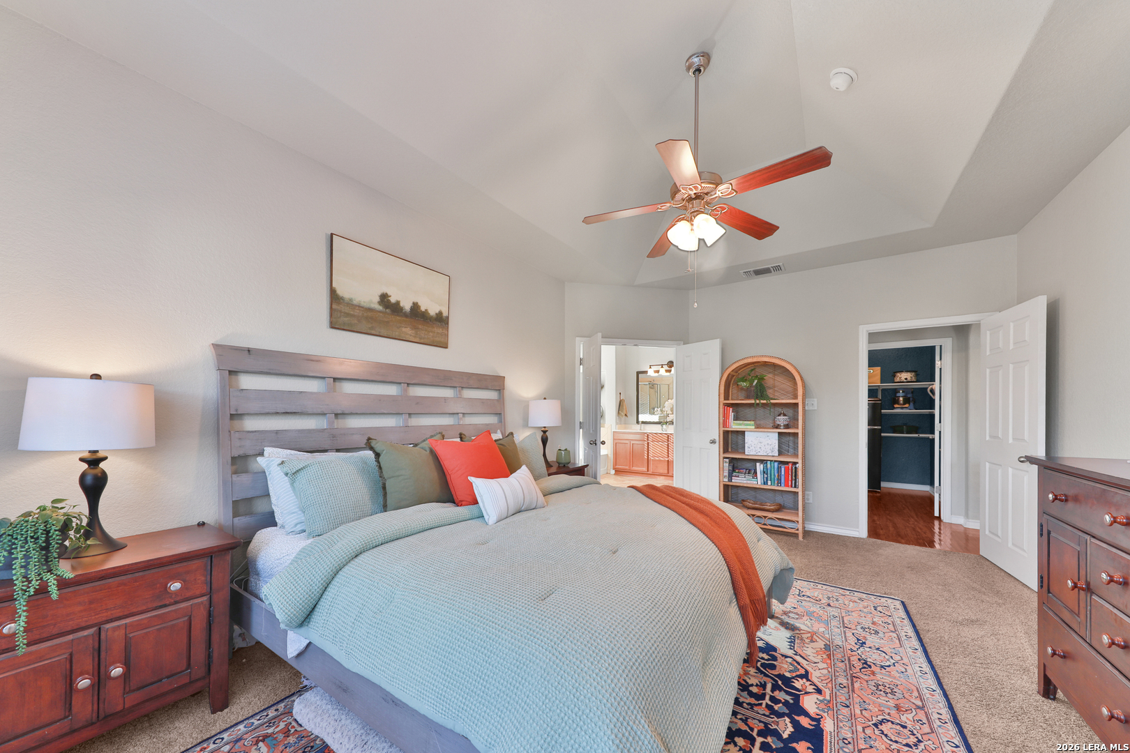 10414 Pecne Path Helotes, TX 78023 - Photo 26 of 42 a bedroom with a bed and a chandelier