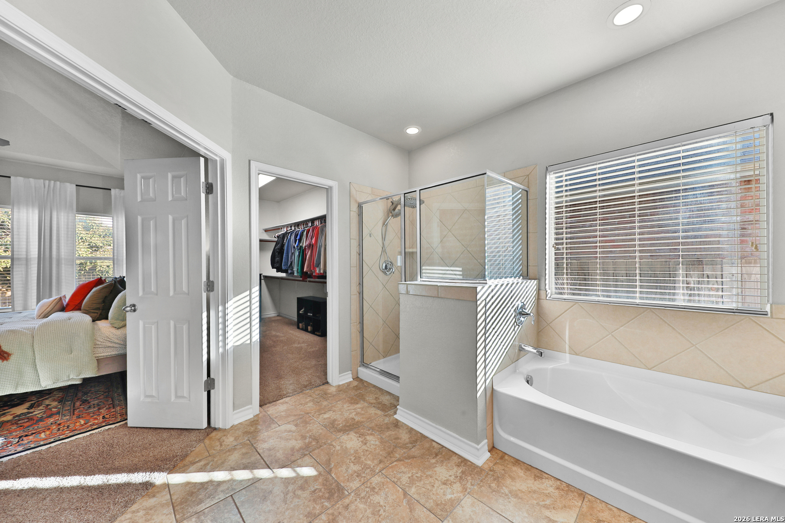10414 Pecne Path Helotes, TX 78023 - Photo 27 of 42 a bathroom with a tub shower and sink