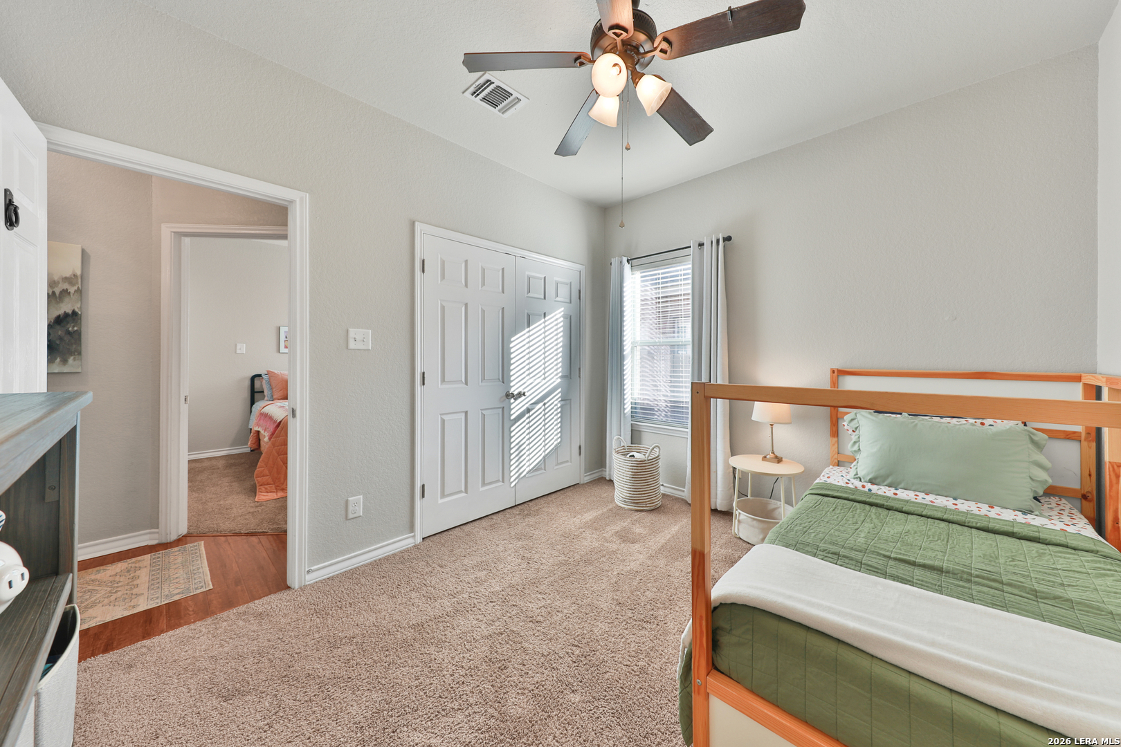 10414 Pecne Path Helotes, TX 78023 - Photo 32 of 42 a bedroom with a bed and a chandelier