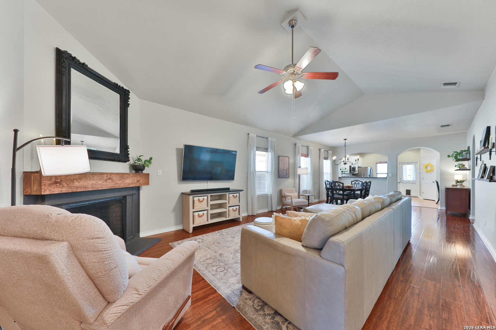 10414 Pecne Path Helotes, TX 78023 - Photo 6 of 42 a living room with furniture a flat screen tv and kitchen view