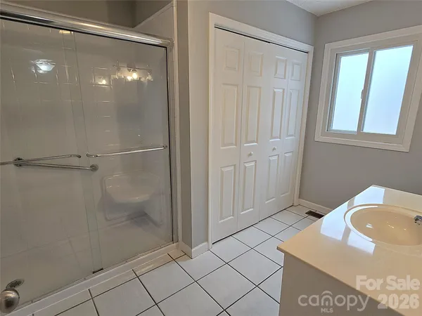 a bathroom with a sink a mirror and shower