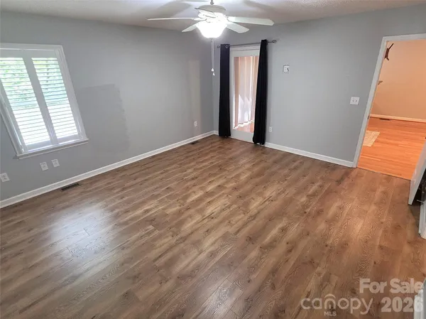 wooden floor in an empty room with a window