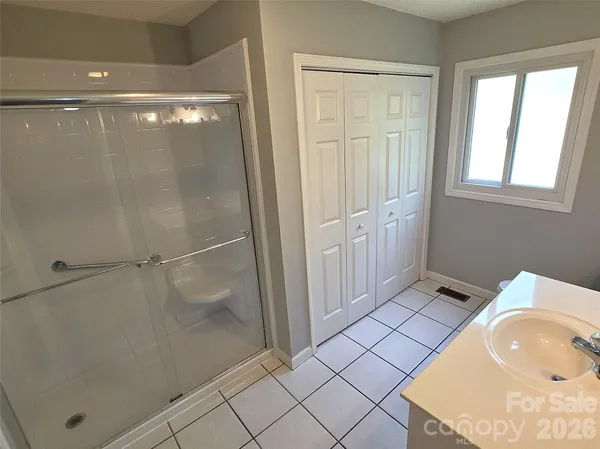 a bathroom with a tub and shower