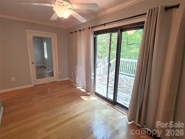 a view of a room with wooden floor and a window
