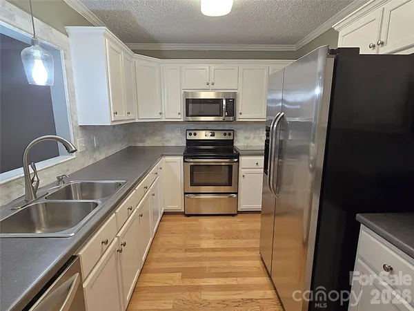 a view of a kitchen from the hallway