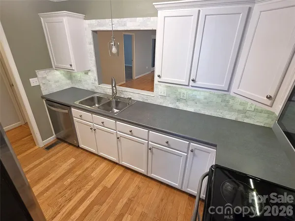 a kitchen with stainless steel appliances granite countertop a sink and a stove