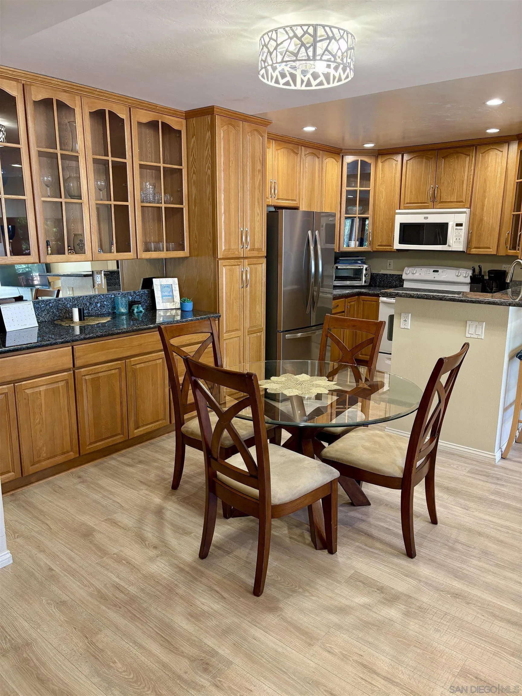 12575 Oaks N Drive, Unit 219 San Diego, CA 92128 - Photo 4 of 17 a view of a dining room with furniture window and outside view