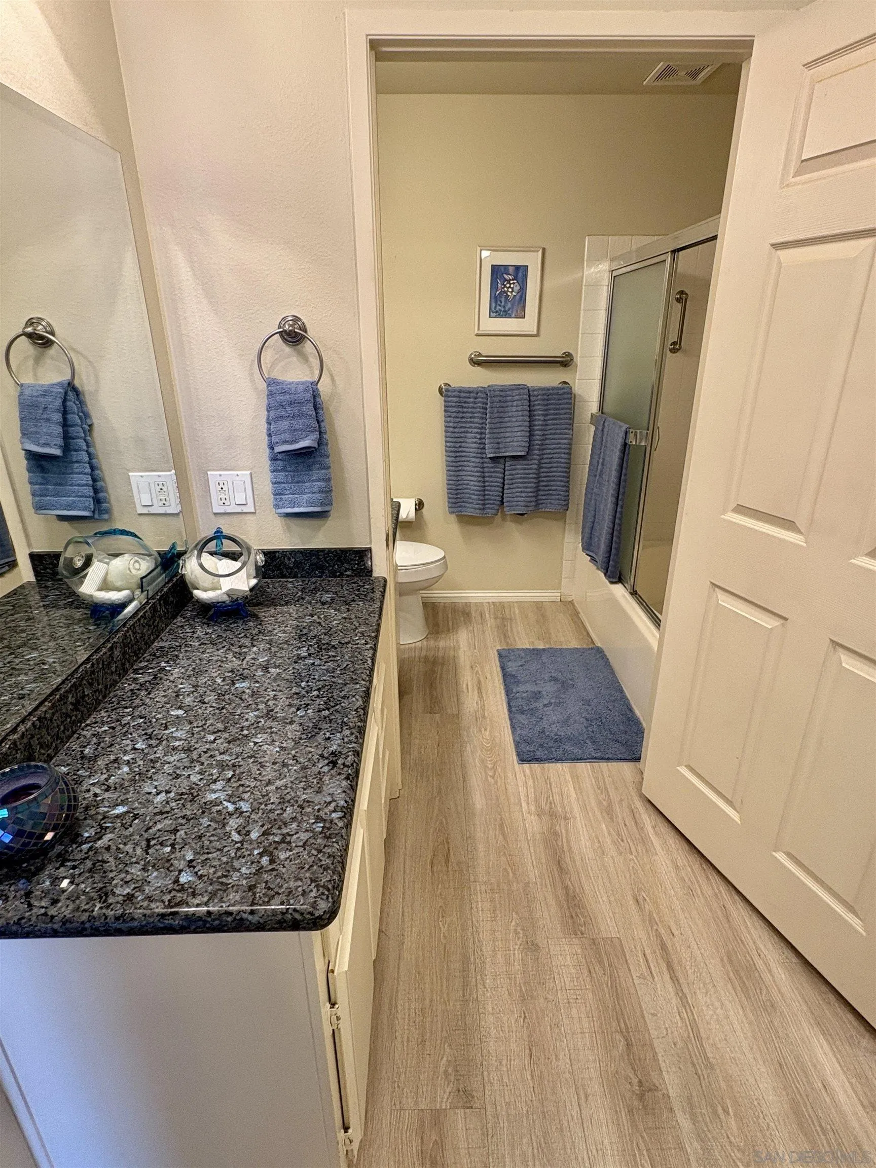 12575 Oaks N Drive, Unit 219 San Diego, CA 92128 - Photo 6 of 17 a living room with stainless steel appliances furniture a rug and a refrigerator