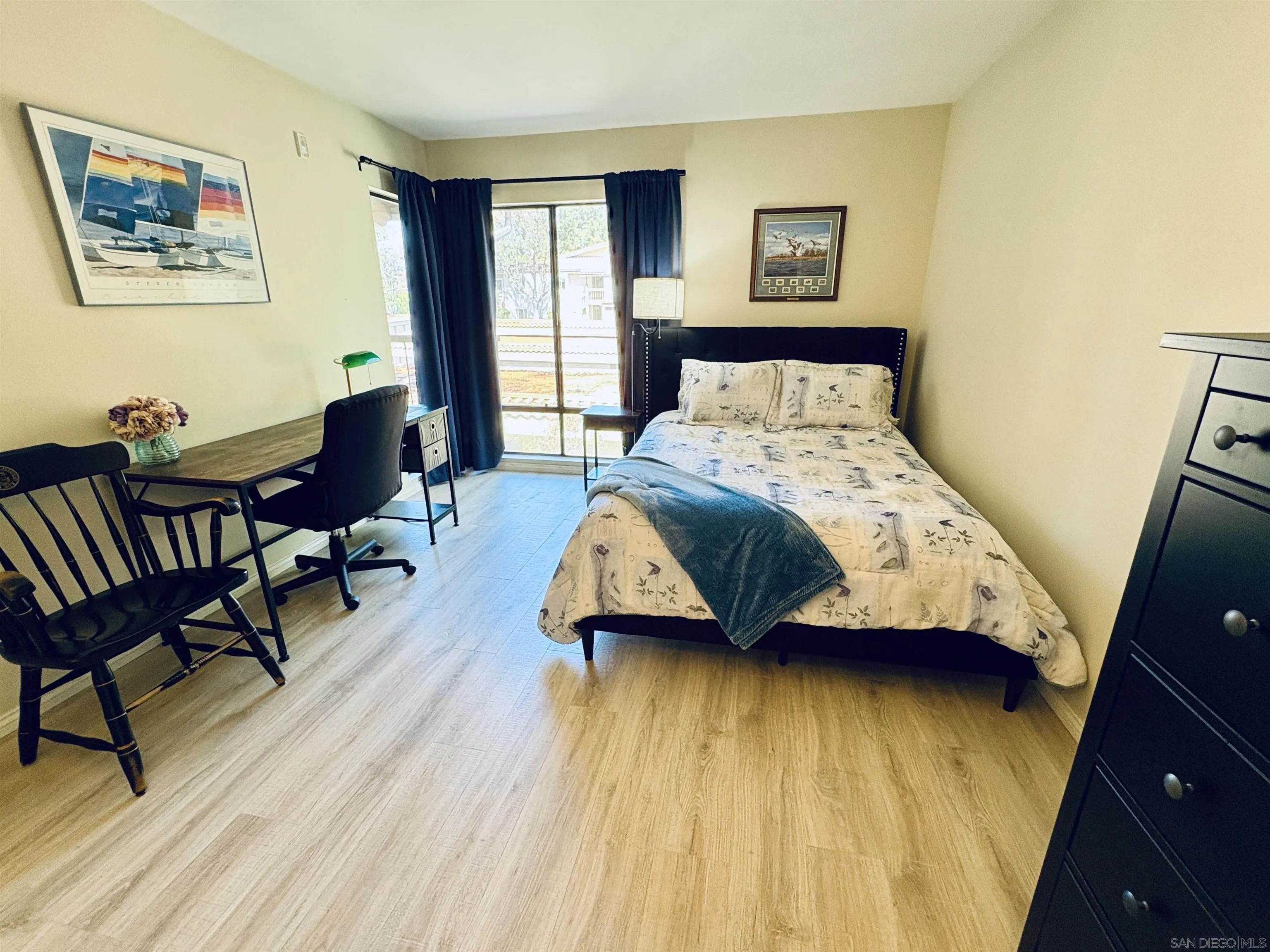 12575 Oaks N Drive, Unit 219 San Diego, CA 92128 - Photo 7 of 17 a bedroom with a bed and wooden floor