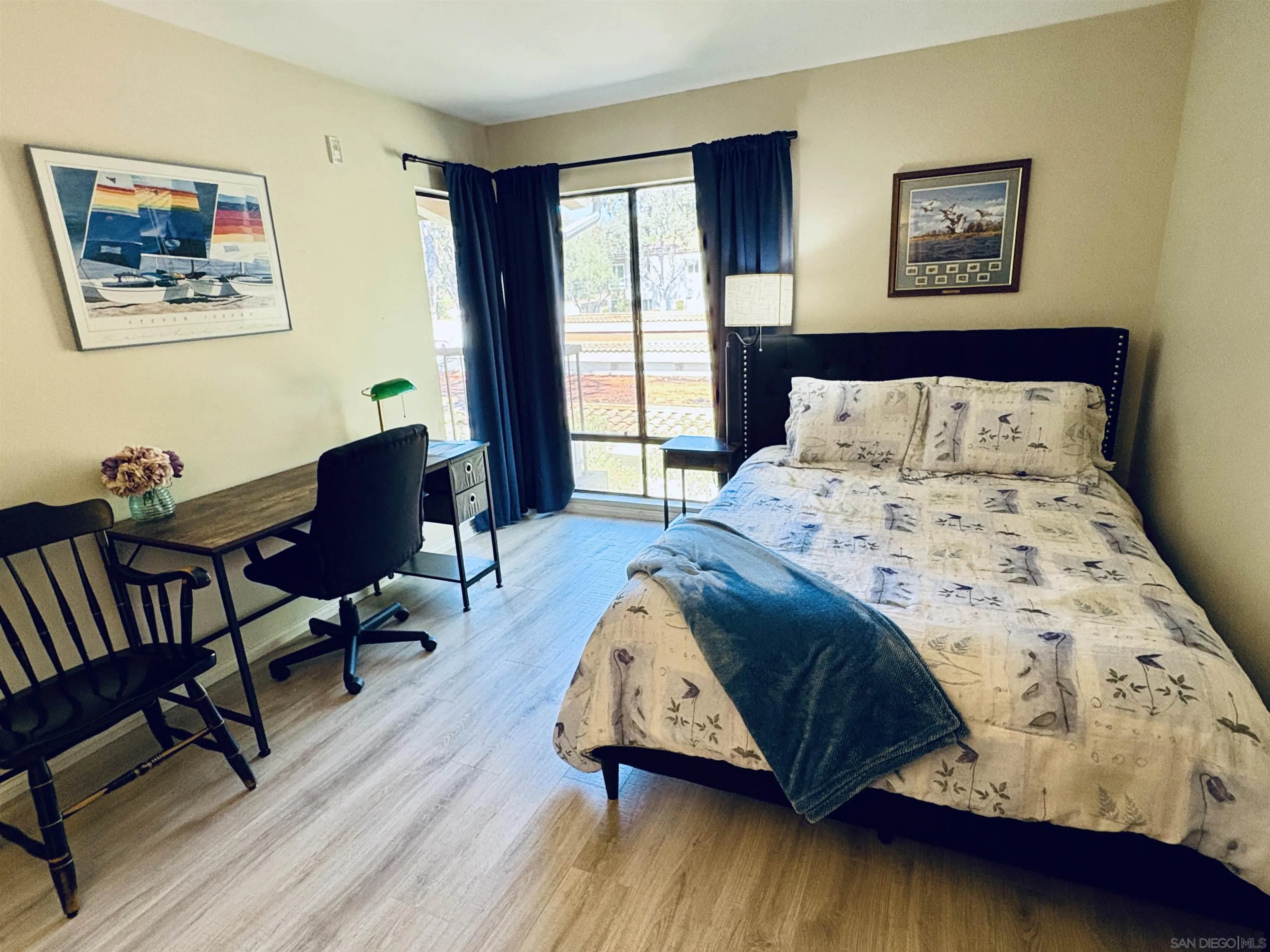 12575 Oaks N Drive, Unit 219 San Diego, CA 92128 - Photo 8 of 17 a bedroom with a bed and wooden floor