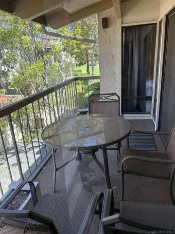 a view of a balcony with furniture and window