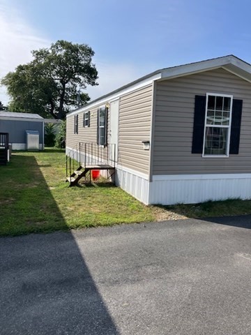 557 Southwest Cutoff, Unit 100 Worcester, MA 01607 - Photo 2 of 31 a front view of a house with a yard and garage
