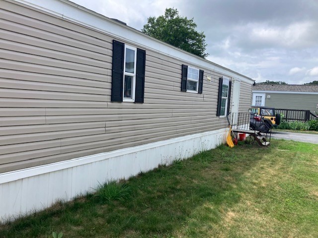 557 Southwest Cutoff, Unit 100 Worcester, MA 01607 - Photo 22 of 31 a view of a backyard with sitting area and garage
