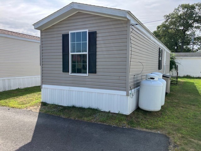 557 Southwest Cutoff, Unit 100 Worcester, MA 01607 - Photo 3 of 31 a view of a small house and a yard with back yard
