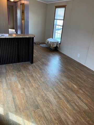 557 Southwest Cutoff, Unit 100 Worcester, MA 01607 - Photo 7 of 31 an empty room with wooden floor and windows