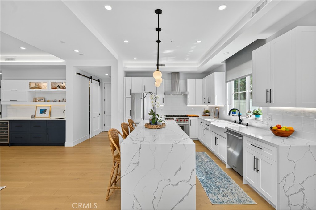 2216 Bataan Road, Unit A Redondo Beach, CA 90278 - Photo 14 of 60 a kitchen with stainless steel appliances kitchen island granite countertop a sink stove and cabinets