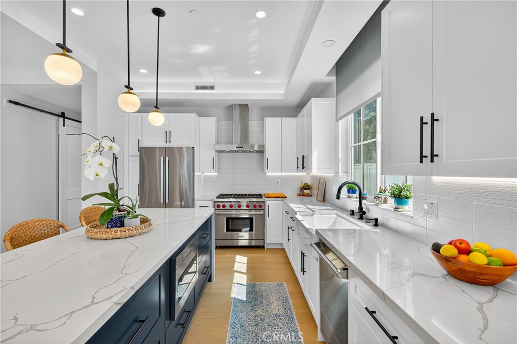 2216 Bataan Road, Unit A Redondo Beach, CA 90278 - Photo 2 of 60 a kitchen with stainless steel appliances a sink a stove and a wooden floors