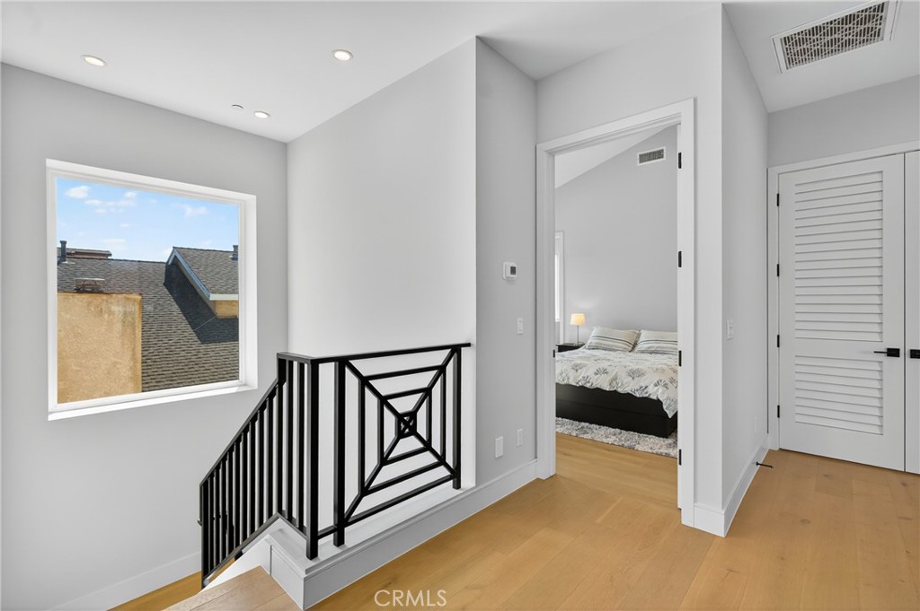 2216 Bataan Road, Unit A Redondo Beach, CA 90278 - Photo 25 of 60 a view of a hallway with a bedroom and wooden floor