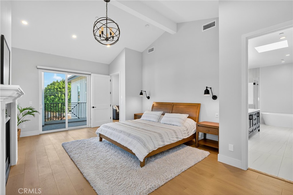 2216 Bataan Road, Unit A Redondo Beach, CA 90278 - Photo 33 of 60 a bedroom with a bed and a chandelier