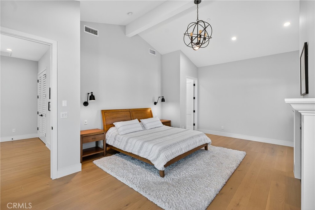 2216 Bataan Road, Unit A Redondo Beach, CA 90278 - Photo 35 of 60 a bedroom with a bed and a chandelier