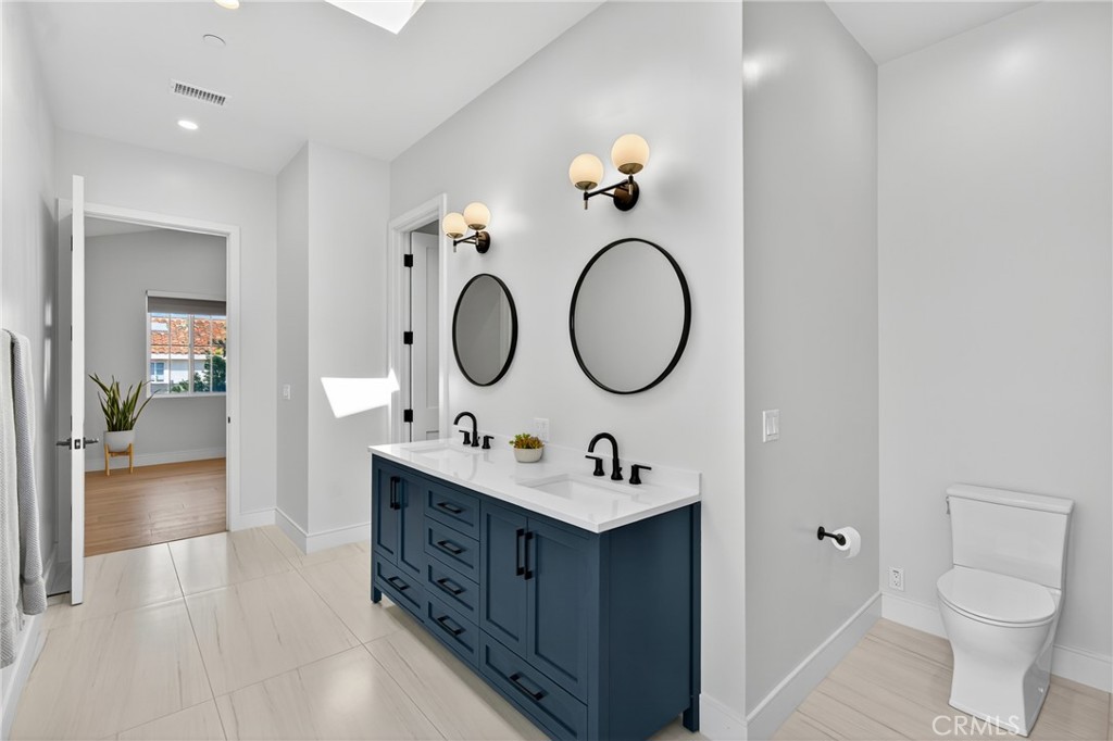 2216 Bataan Road, Unit A Redondo Beach, CA 90278 - Photo 38 of 60 a bathroom with a toilet sink vanity granite and a mirror