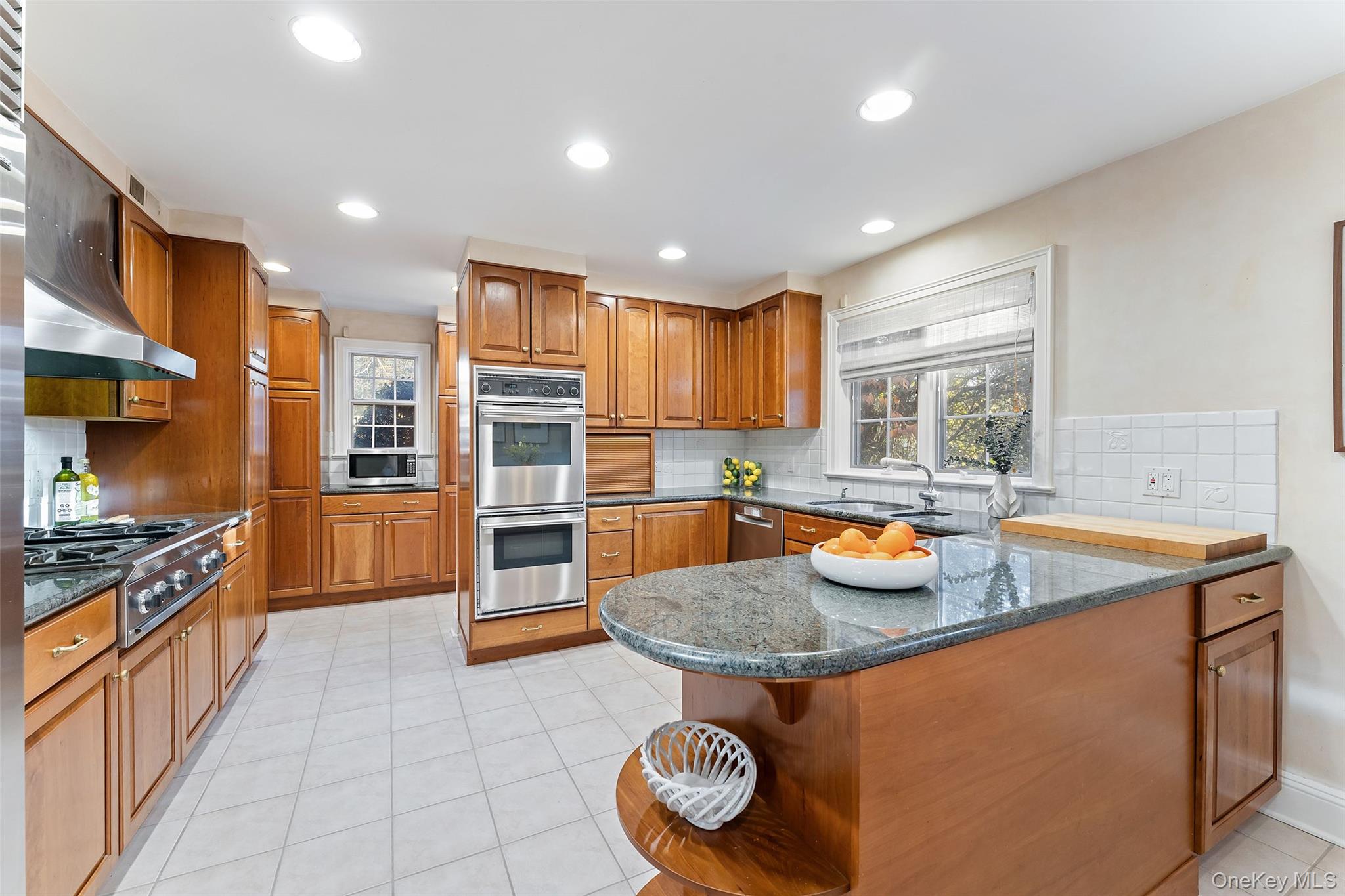 24 Olmsted Road Scarsdale, NY 10583 - Photo 11 of 39 a kitchen with stainless steel appliances granite countertop a sink stove and refrigerator