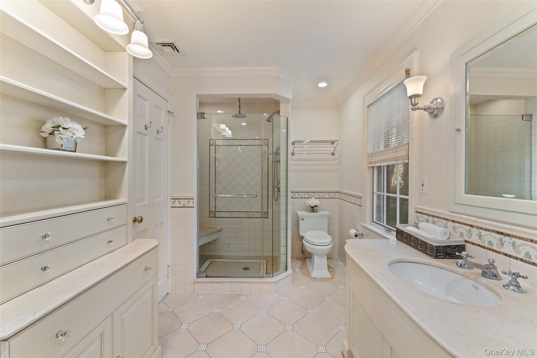 24 Olmsted Road Scarsdale, NY 10583 - Photo 19 of 39 a bathroom with a shower sink and mirror