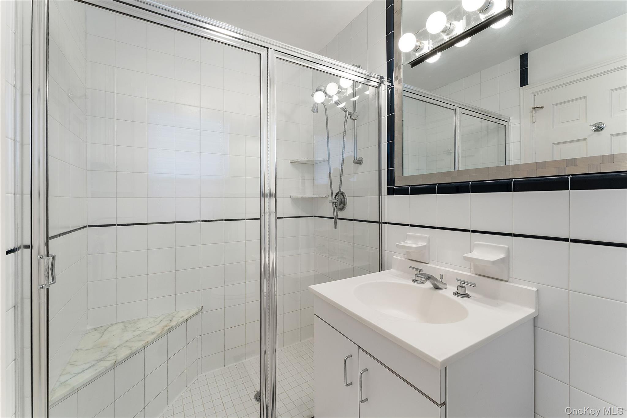 24 Olmsted Road Scarsdale, NY 10583 - Photo 21 of 39 a bathroom with a sink mirror and shower