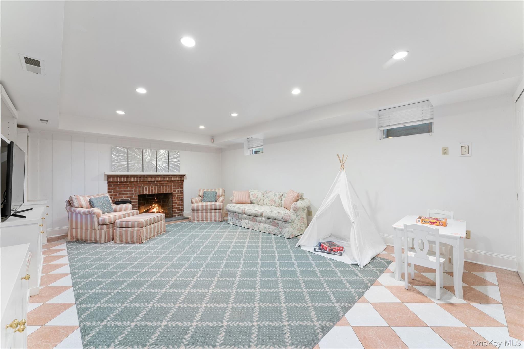 24 Olmsted Road Scarsdale, NY 10583 - Photo 26 of 39 a living room with furniture and a fireplace