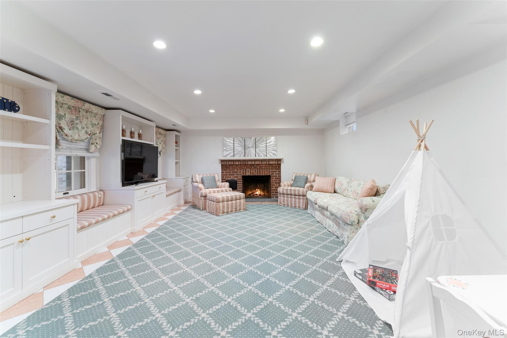 24 Olmsted Road Scarsdale, NY 10583 - Photo 27 of 39 a living room with furniture and a fireplace